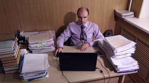 Office worker sits at a table in office Stock Footage 72691525