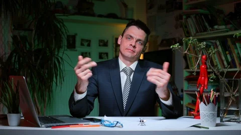 An office worker sitting at a desk demonstrates a game of emotions. Stock Footage 128100098
