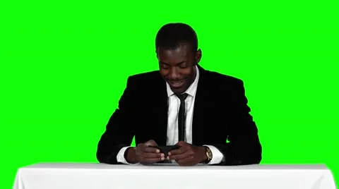 Office worker sitting at the table and use the phone. Green screen Stock Footage 62811330