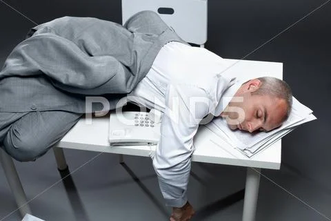 Office worker sleeping on his table Stock Photos