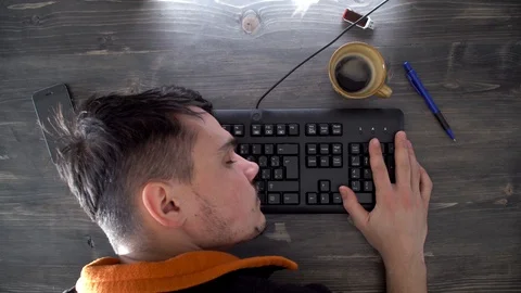 An office worker sleeps on a keyboard Stock Footage 124360698