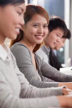 Office Worker Smiling and Looking at Camera Stock Photos