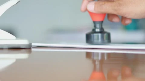 Office worker stamping document for approval Stock Footage 345549916