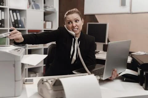 Office worker stressed. Overworked concept. Angry furious woman. Stock Photos