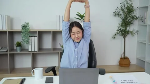 Office worker stretches during a computer work break Stock Footage 348329773