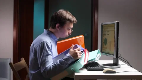 Office worker struggling with excessive paperwork at computer desk Stock Footage 309241751
