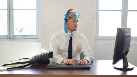 Office worker in suit with tie needing holidays: wearing a diving mask and Stock Footage 143306321