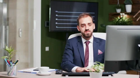 Office worker in suit types on computer keyboard, then looks at the time Stock Footage 109607473