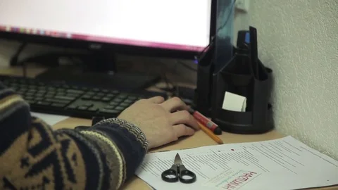 Office worker in a sweater at the table working on the computer, move the mouse Stock Footage 71836486