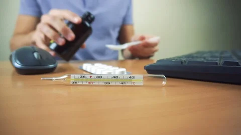 Office worker take cough while working in office. Thermometer and tablets Stock Footage 83378491