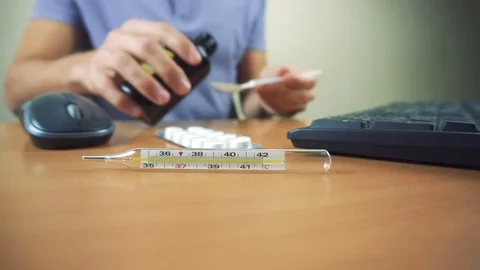 Office worker take cough while working in office. Thermometer and tablets Video stock 83509585