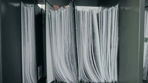 Office worker takes a folder with documents from the document rack Stock Footage 197028866