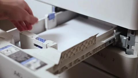 Office worker takes out a stack of paper from the printer tray Stock Footage 294628211