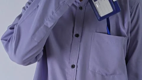 Office worker taking blue ID badge template out of his shirt pocket Stock Footage 337129490
