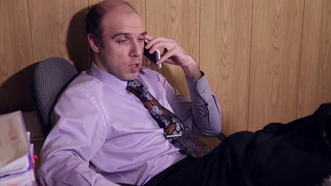 Office worker is talking on the mobile phone Stock Footage 72691741