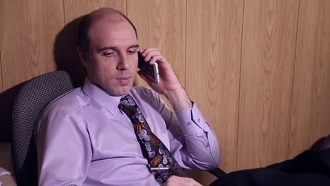 Office worker is talking on the mobile phone Stock Footage 72691812
