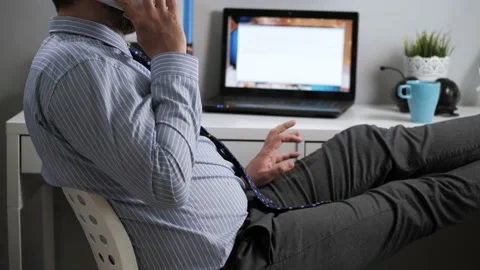 Office worker talking on phone. Bearded man in shirt and tie sitting relaxed at Video stock 130305019