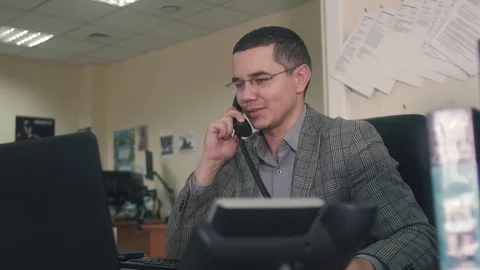 Office worker talking on the phone in the workplace Stock Footage 82088422