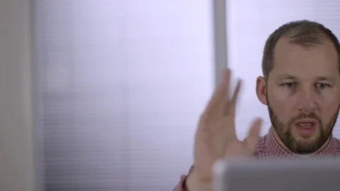 An office worker talking on a video conference in a modern office Stock Footage 73124364