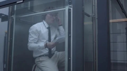 Office worker talks with clients in elevator Stock Footage 333967287