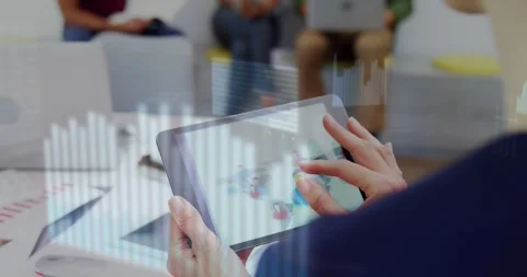 Office worker tapping tablet and swiping, bringing floating bar and line charts Stockbeeldmateriaal 329115301