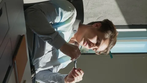 Office Worker Thinks How to Solve a Problem. He Sits At A Table And Twirls A Pen Vidéo 129130070