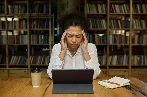 Office worker touching head massaging temples suffering from headache or tension Stock Photos