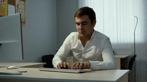 Office worker typing on computer, takes incoming call and speaks on the phone Video stock 111921503