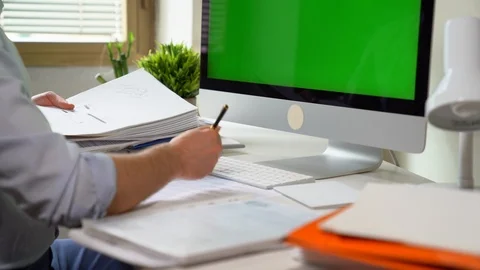 Office-worker typing on desktop keyboard and business report paper or piles of Stock-Footage 104991076