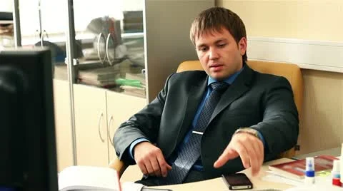 Office worker typing on the keyboard. Suddenly the man puts on gas mask. Stock Footage 21318385