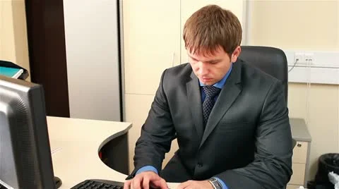 Office worker typing on the keyboard. Suddenly the man puts on gas mask. Stock Footage 21318581