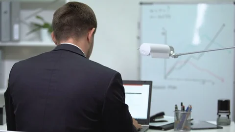Office worker typing on laptop, suddenly feeling eye tension, stressful workday Stock-Footage 117174883