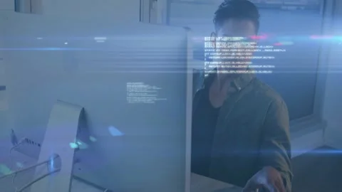Office worker typing then grabbing phone as blue code overlays intensifying, Stock Footage 332544556