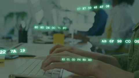Office worker typing on white keyboard on shared desk, causing green data Stock Footage 333632194