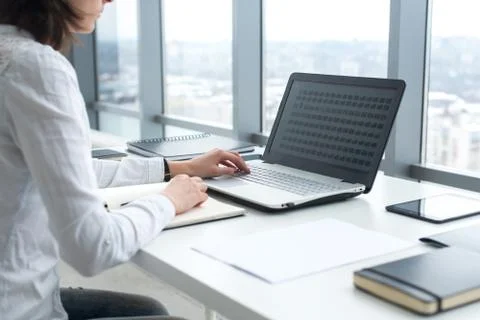 Office worker typing, working at her workplace, using laptop Stock Photos