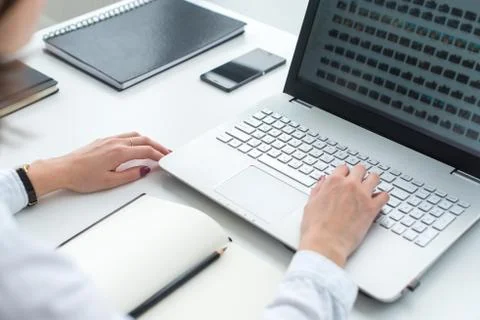 Office worker typing, working at her workplace, using laptop Stock Photos