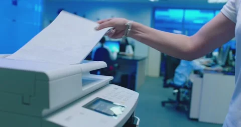 Office worker use print machine on blurred office background Stock Footage 132569556