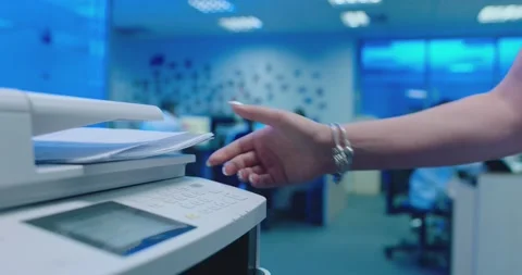 Office worker use print machine on blurred office background Stock Footage 132569767