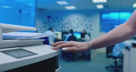 Office worker use print machine on blurred office background Stock Footage 132569864