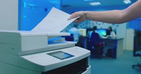 Office worker use print machine on blurred office background Stock Footage 132569906