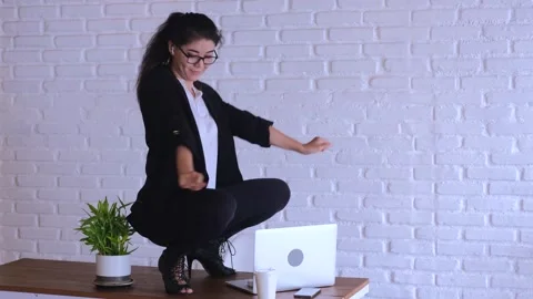 Office worker uses break to spontaneously dance on desk. Unusual break creates Stock Footage 278508635