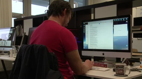 Office Worker Uses Computer at his Desk Stock Footage 58241350