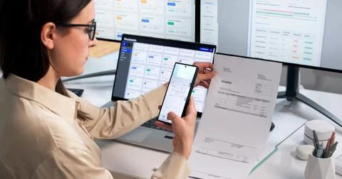 Office Worker Uses Smartphone To Scan Invoice And Prevent Document Fraud. Stock Photos