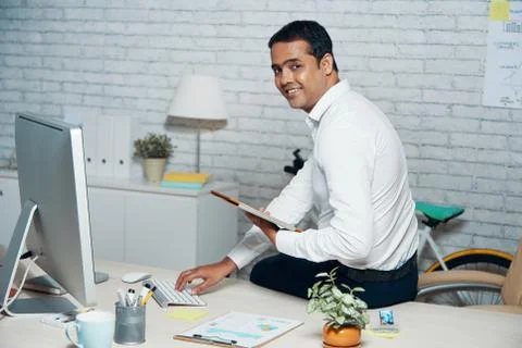 Office worker using computer and tablet pc in his work Stock Photos