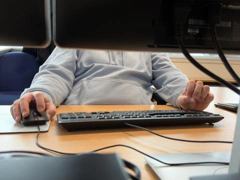 Office worker using computer at desk Stock Photos