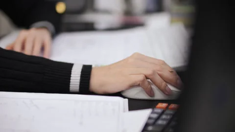 Office worker using computer mouse near calculator Stock Footage 326233864