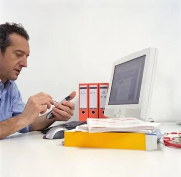Office worker using a handheld computer Stock Photos