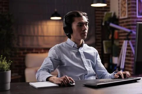 Office worker using headphones and working Stock Photos