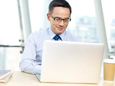 Office worker using laptop computer Stock Photos