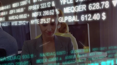 Office worker using laptop, live feed expanding FOREX NASDAQ tickers overlaying Stock Footage 332505382